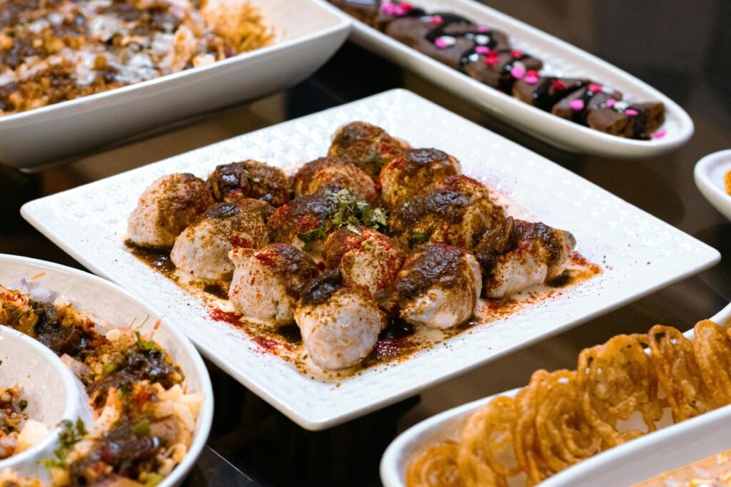 A vibrant display of Indian street food featuring dahi vada, showcasing rich spices and diverse flavors.