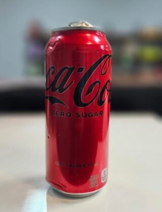 Coca-Cola Zero Sugar can with a sleek design, showcasing its sugar-free refreshment.
