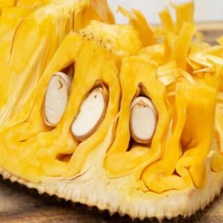 Fresh jackfruit displayed on a wooden surface