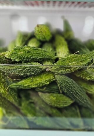 Fresh karela (bitter melon) on a white background